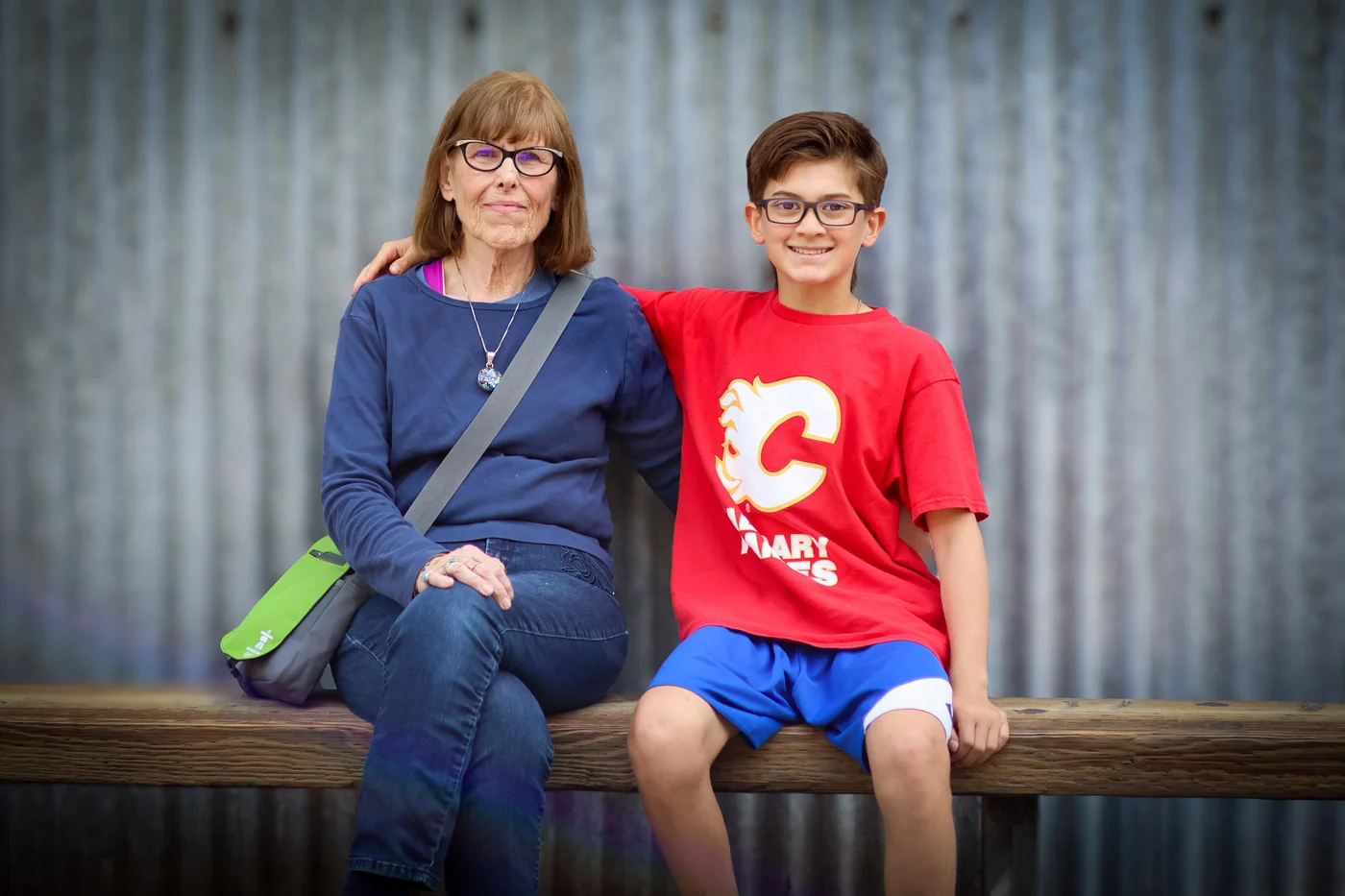 A grandmother and child sitting together for a smiling portrait